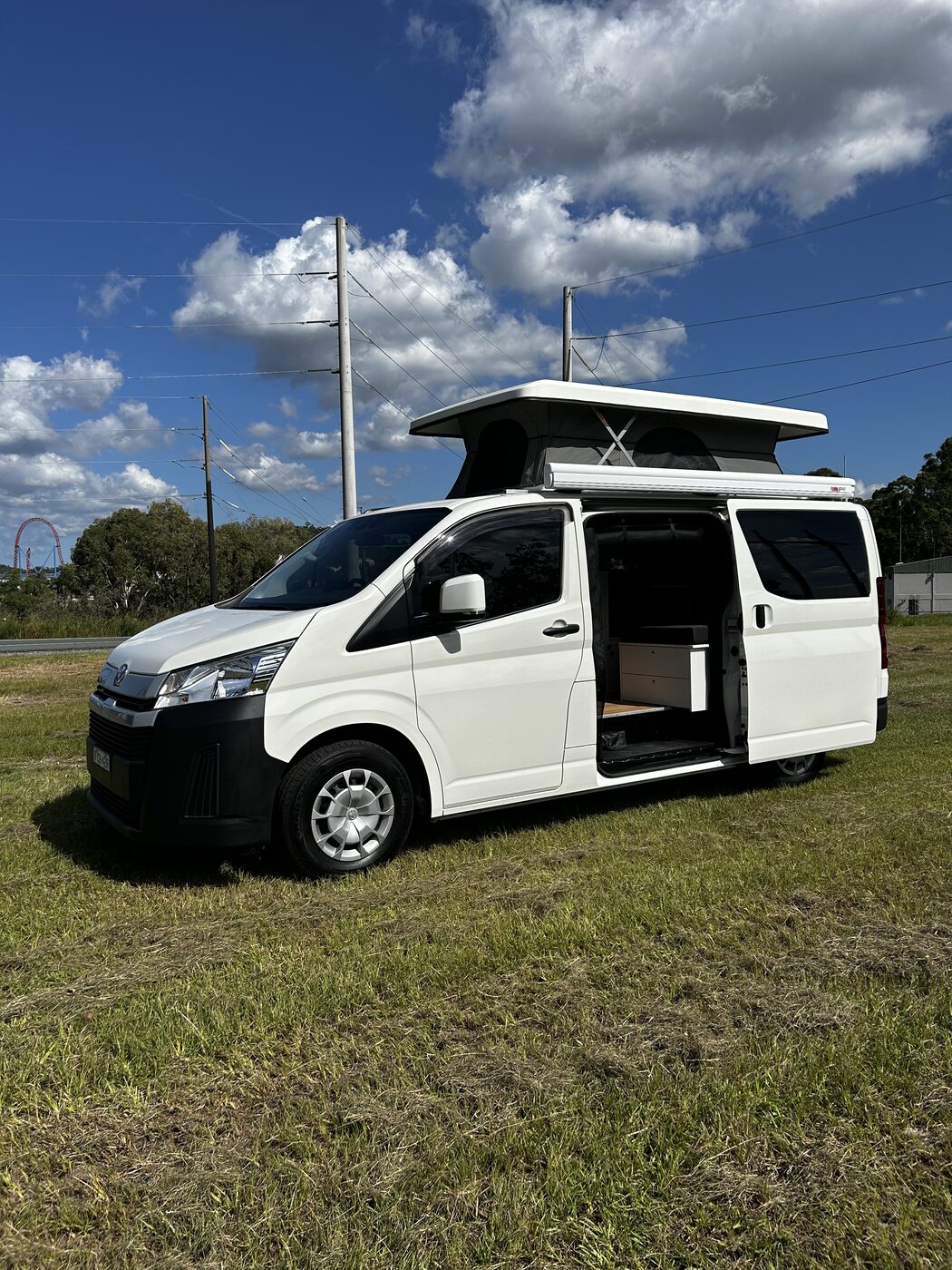 White HiAce custom fitout, pop-top raised and side door open