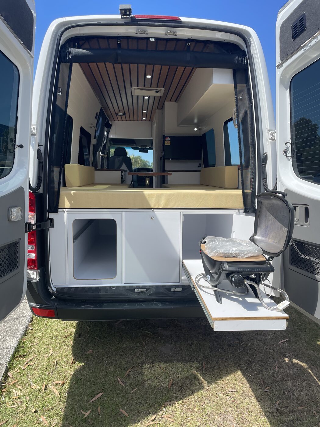 Rear bed and under-bed storage with slide-out grill