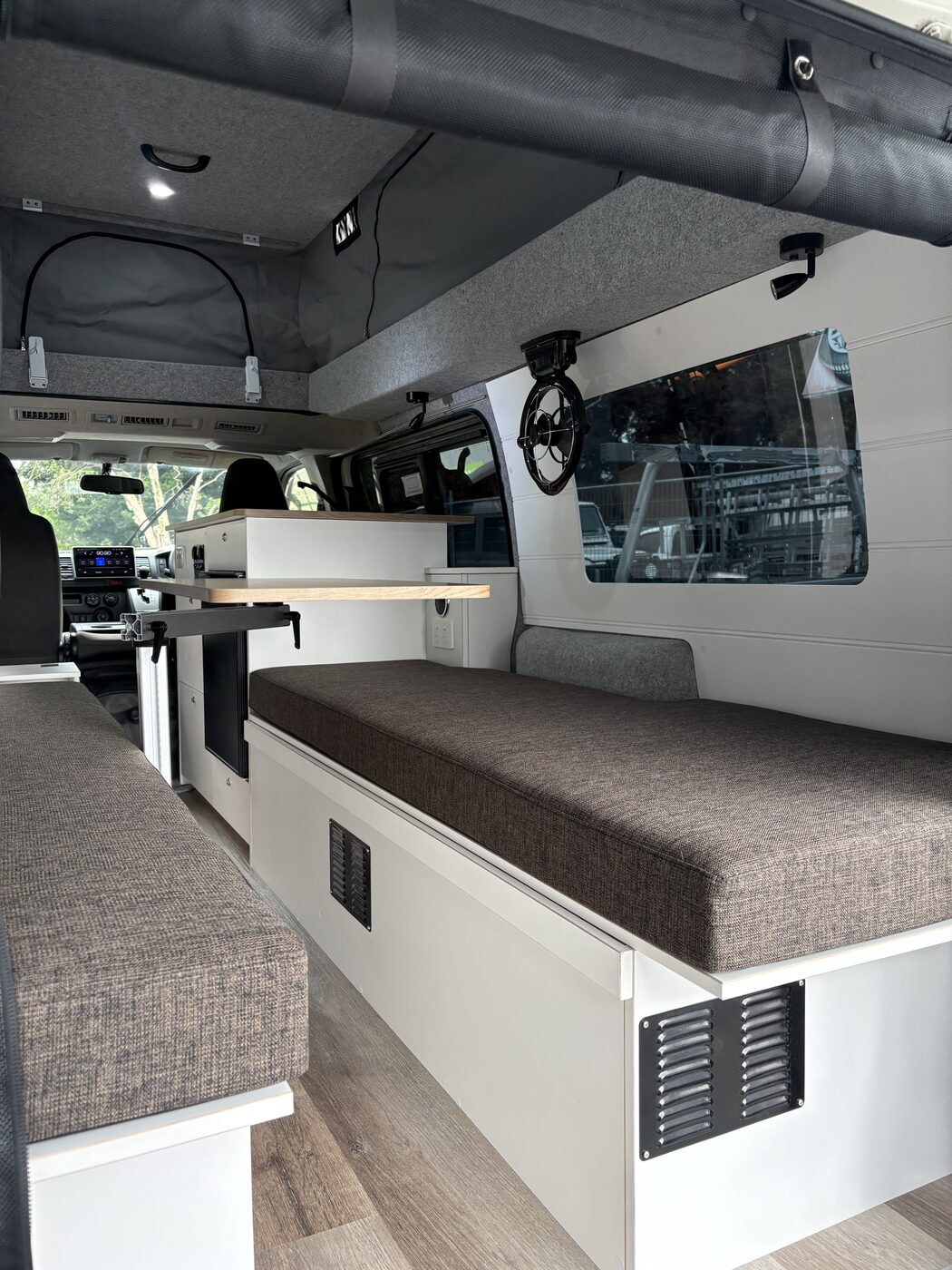 Pop-top interior with twin benches, swivel table and kitchen
