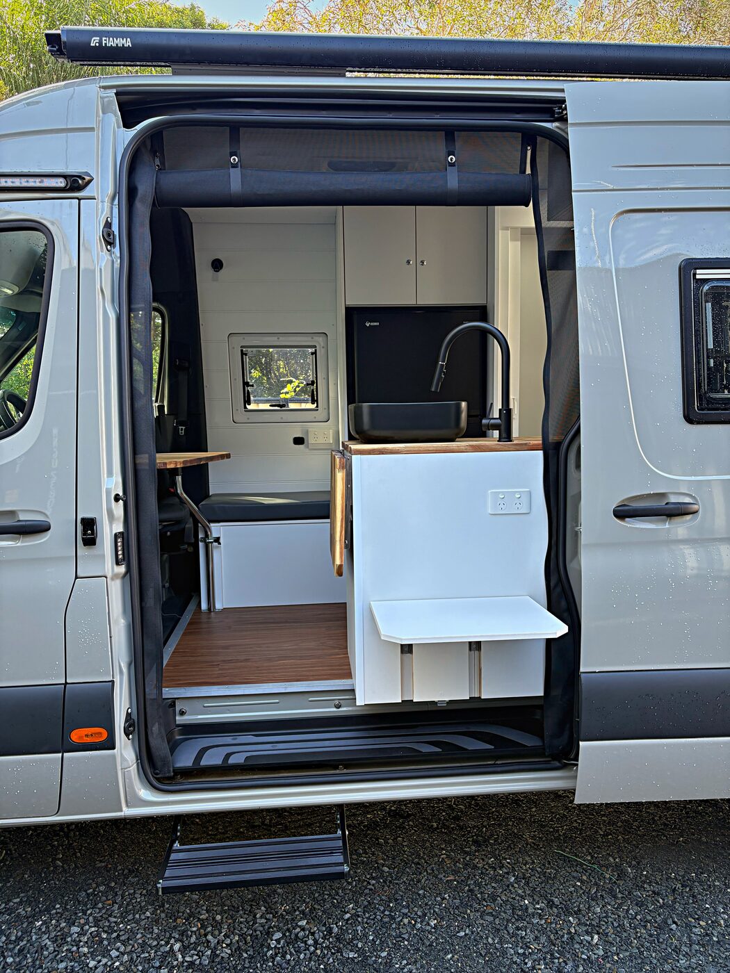 Kitchen sink, fridge and dinette through the side door