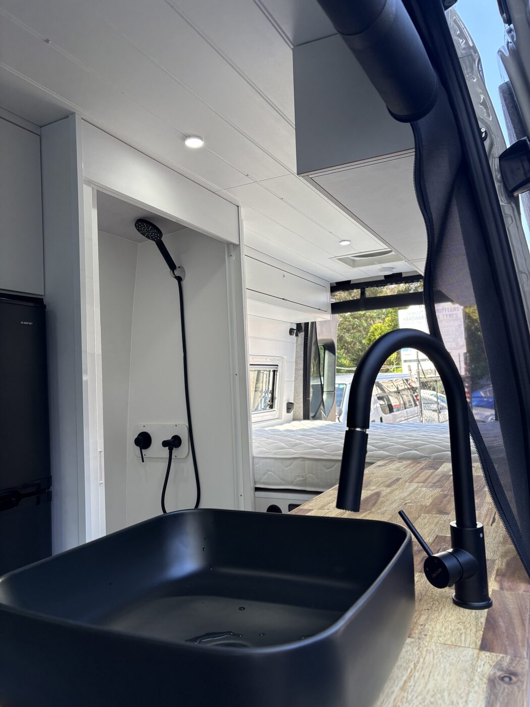 Kitchen, enclosed shower and rear bed