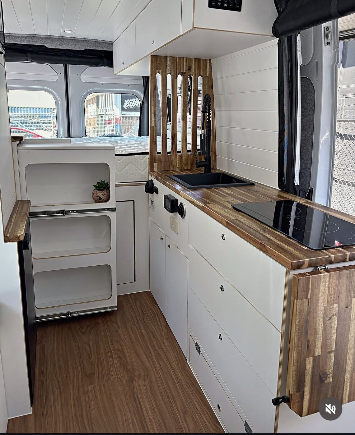 Kitchen bench, cooktop, storage cubbies and rear bed